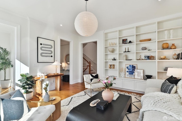 living room featuring light hardwood / wood-style floors and built in shelves