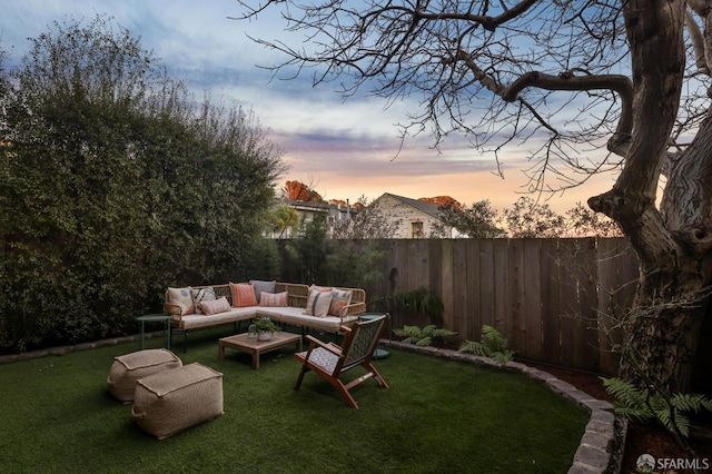 yard at dusk featuring an outdoor hangout area