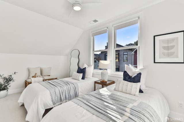 carpeted bedroom featuring vaulted ceiling and ceiling fan