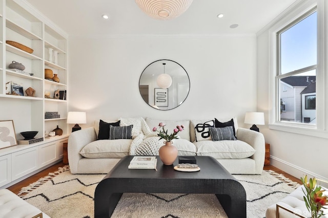 living room with hardwood / wood-style flooring and ornamental molding