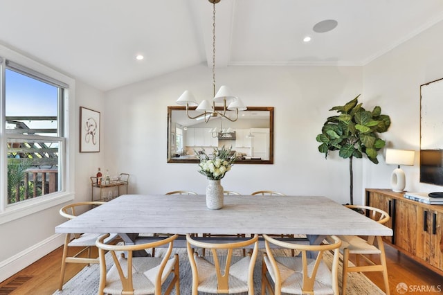 dining room featuring lofted ceiling with beams, an inviting chandelier, plenty of natural light, and wood-type flooring