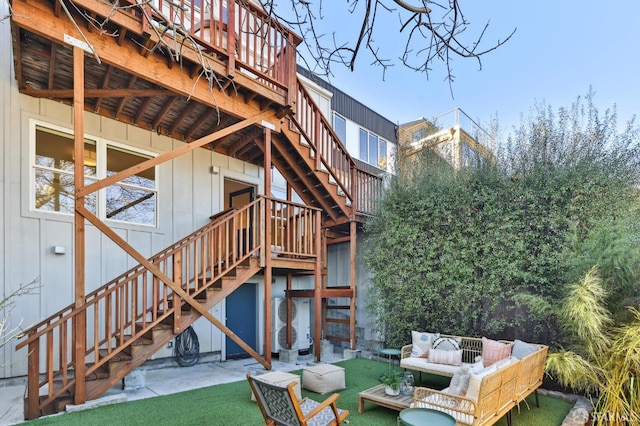 back of house with a patio area, outdoor lounge area, and a wooden deck