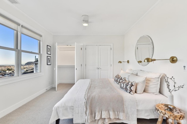 carpeted bedroom featuring ceiling fan and ornamental molding