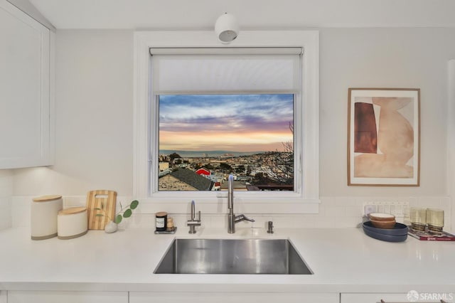 kitchen with sink, white cabinetry, and plenty of natural light