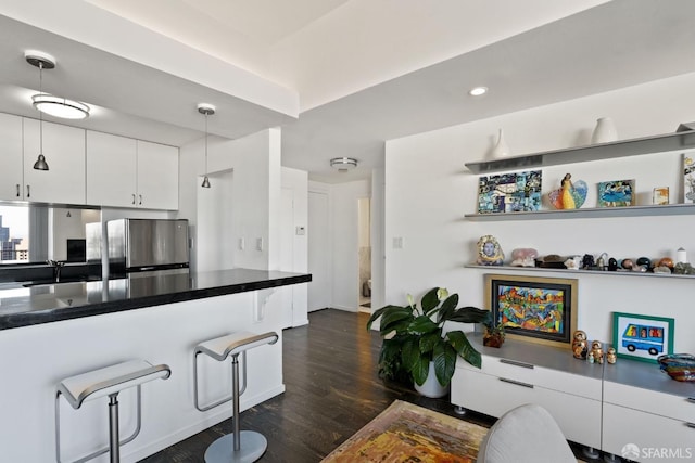 living room featuring dark wood-type flooring and sink