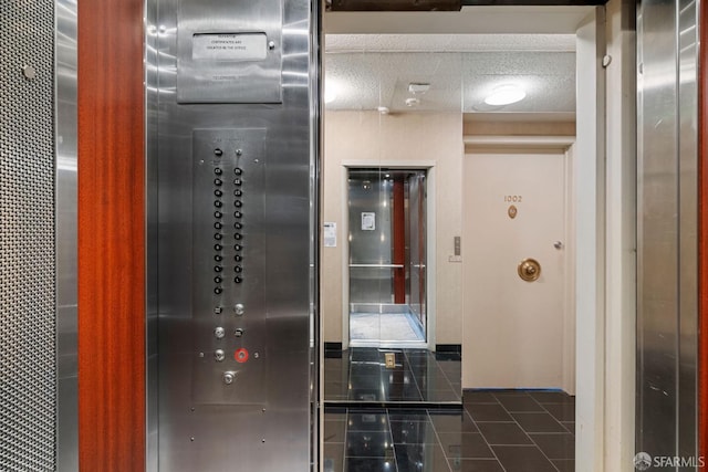 interior space with tile patterned flooring and a textured ceiling