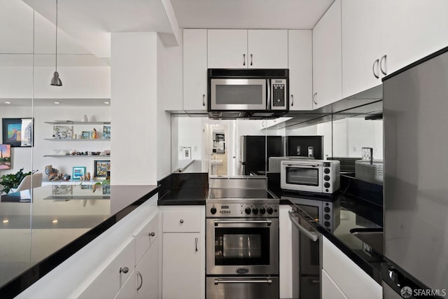 kitchen with appliances with stainless steel finishes and white cabinetry