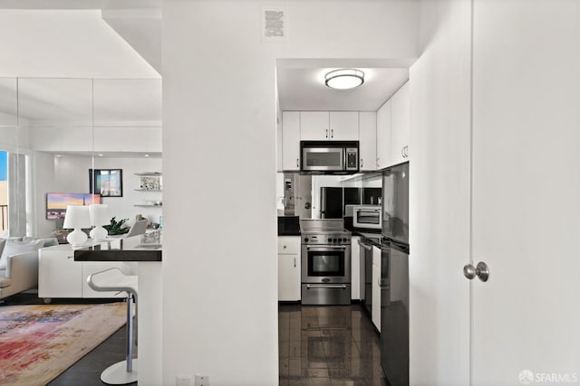 kitchen featuring appliances with stainless steel finishes and white cabinets