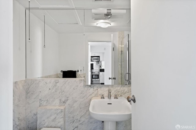 bathroom with sink and an enclosed shower