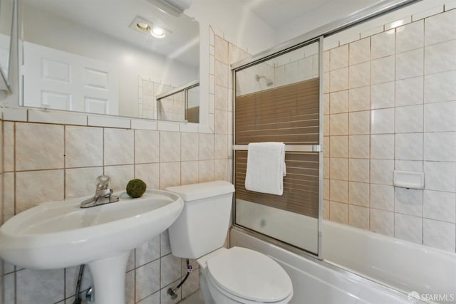1826 Moraga St, San Francisco, CA 94122 - bathroom featuring tile walls, toilet, enclosed tub / shower combo, decorative backsplash, and a sink