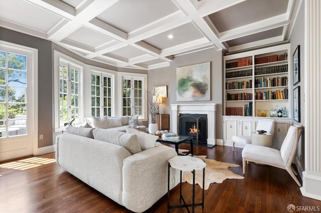 living room featuring built in shelves, coffered ceiling, dark hardwood / wood-style flooring, and beam ceiling