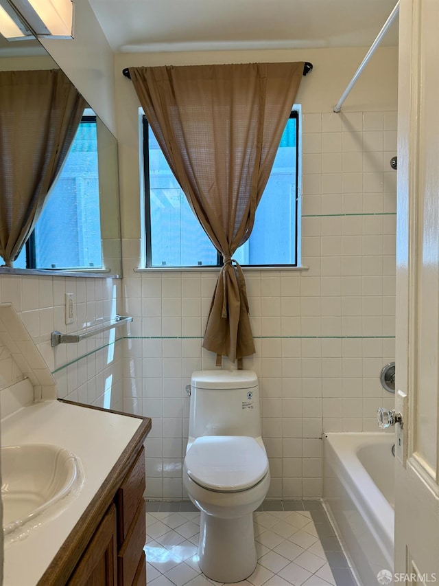 3543-3545 24th St, San Francisco, CA 94110 - bathroom with tile walls, vanity, toilet, tile patterned flooring, and bathtub / shower combination