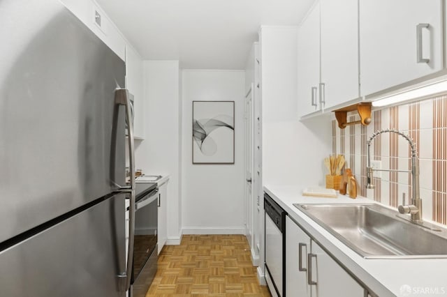 kitchen with black range with electric cooktop, a sink, freestanding refrigerator, dishwasher, and tasteful backsplash