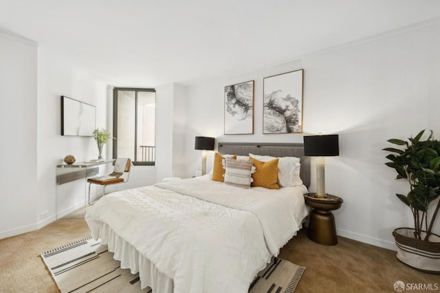 bedroom featuring carpet and baseboards