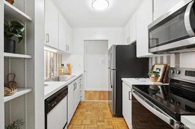 kitchen featuring a sink, white cabinets, light countertops, appliances with stainless steel finishes, and decorative backsplash