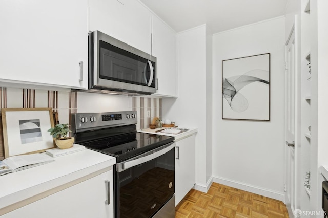 kitchen with stainless steel appliances, light countertops, white cabinets, and tasteful backsplash