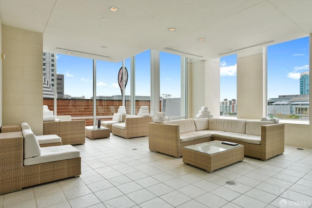 interior space with light tile patterned floors, expansive windows, a view of city, and a healthy amount of sunlight