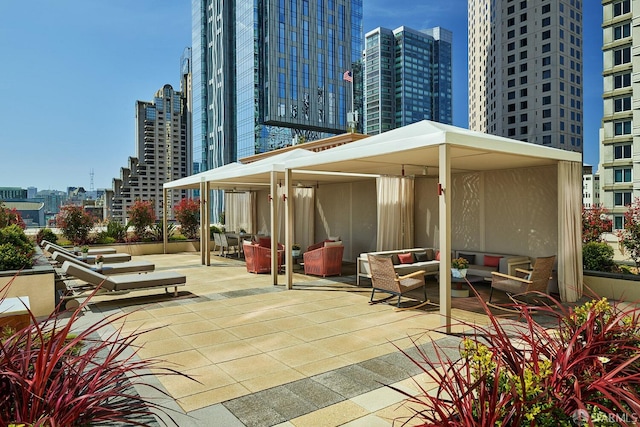 view of patio with an outdoor living space and a city view