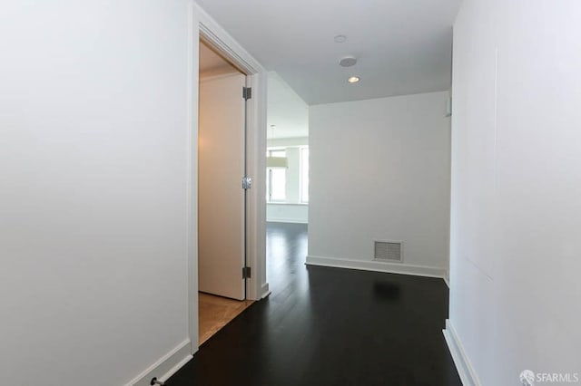 corridor featuring recessed lighting, wood finished floors, visible vents, and baseboards