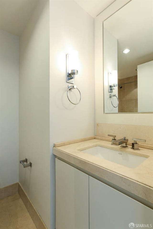 bathroom featuring baseboards, vanity, and tile patterned flooring