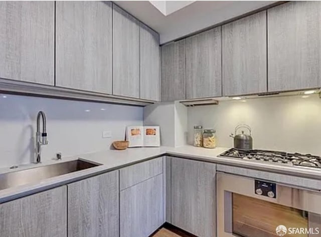 333 Beale St Unit 6J, San Francisco, CA 94105 - kitchen with modern cabinets, oven, light countertops, and stainless steel gas stovetop
