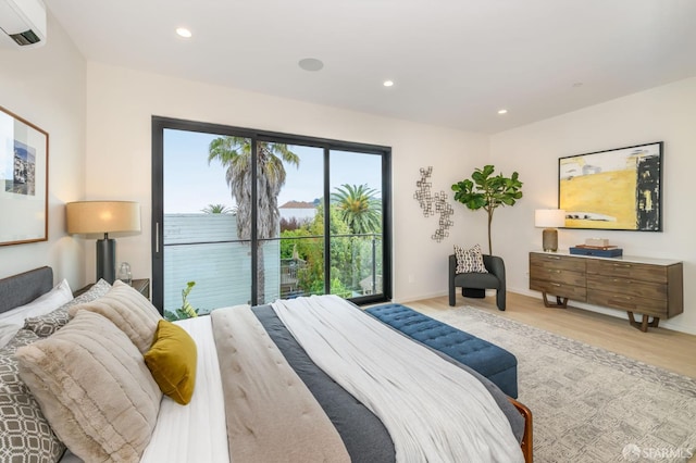 bedroom with recessed lighting, baseboards, light wood-style floors, access to outside, and a wall mounted AC