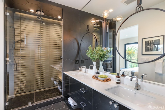 ensuite bathroom with ensuite bath, tile patterned flooring, a sink, and visible vents