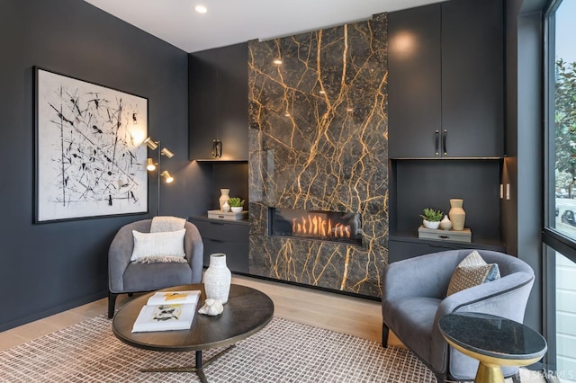 living area featuring a fireplace, wood finished floors, and recessed lighting