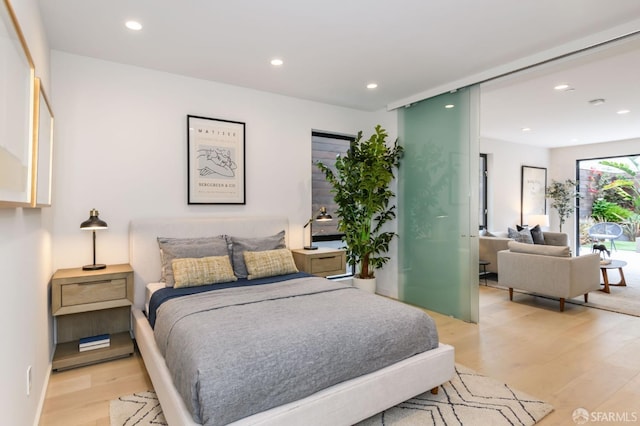 bedroom with light wood-style flooring and recessed lighting