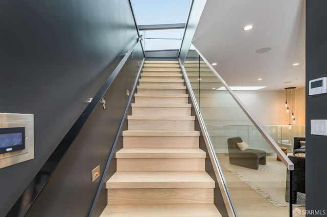 stairway featuring recessed lighting and wood finished floors