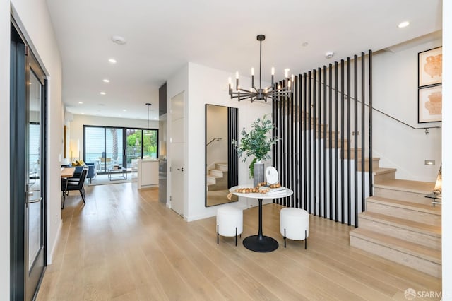 interior space featuring a chandelier, recessed lighting, stairway, and light wood finished floors