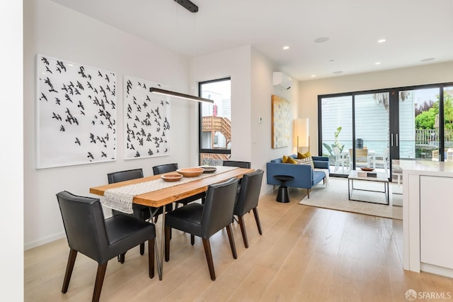 dining space featuring recessed lighting, light wood-style flooring, baseboards, and a wall mounted AC