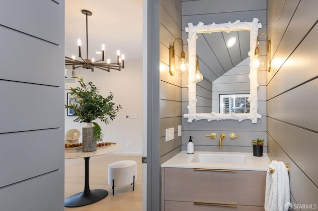 bathroom featuring lofted ceiling, wood finished floors, and vanity