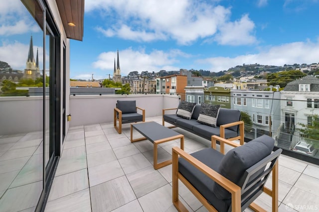 balcony featuring a view of city and an outdoor hangout area