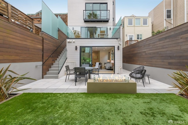 back of property featuring stairs, a patio, and a yard