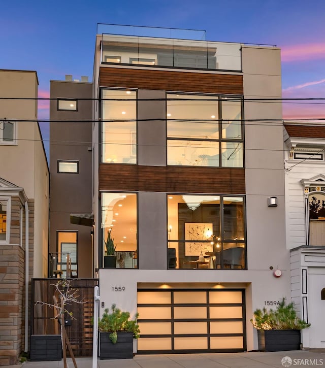 view of front of home with an attached garage and stucco siding