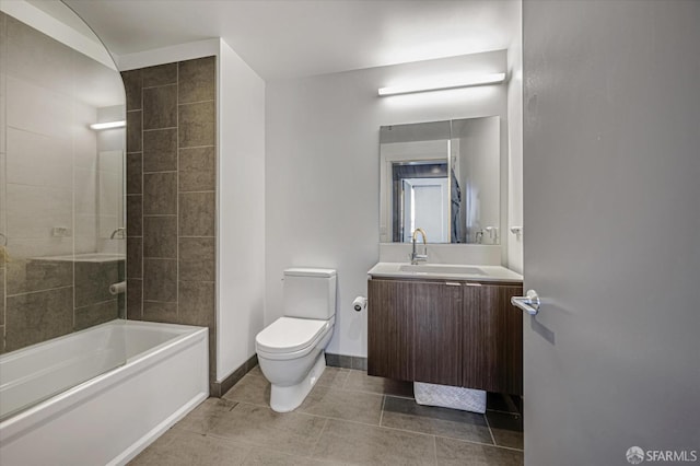 full bathroom featuring toilet, tiled shower / bath, tile patterned floors, and vanity