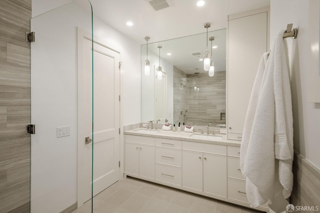 3537 23rd St Unit A, San Francisco, CA 94110 - bathroom featuring double vanity, visible vents, a stall shower, and a sink