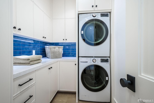3537 23rd St Unit A, San Francisco, CA 94110 - washroom featuring stacked washer / dryer and cabinet space
