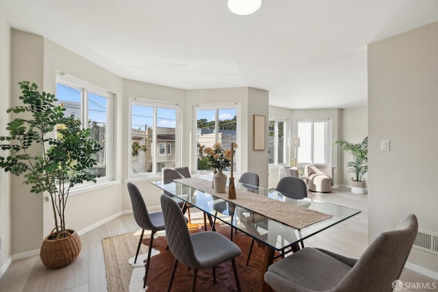 dining room featuring baseboards and wood finished floors