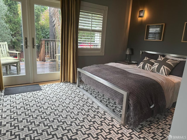 bedroom with french doors, access to outside, and multiple windows