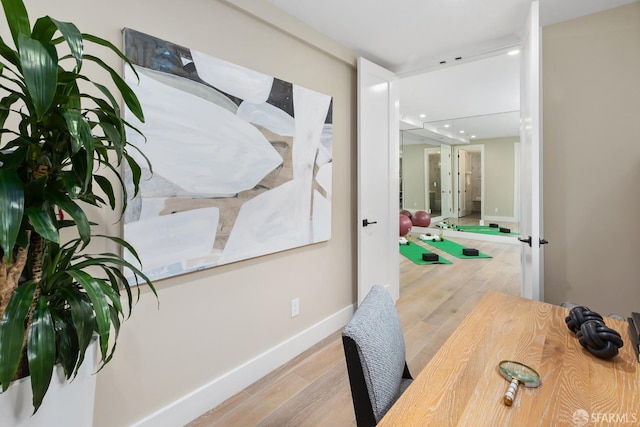 office space with french doors and light wood-type flooring