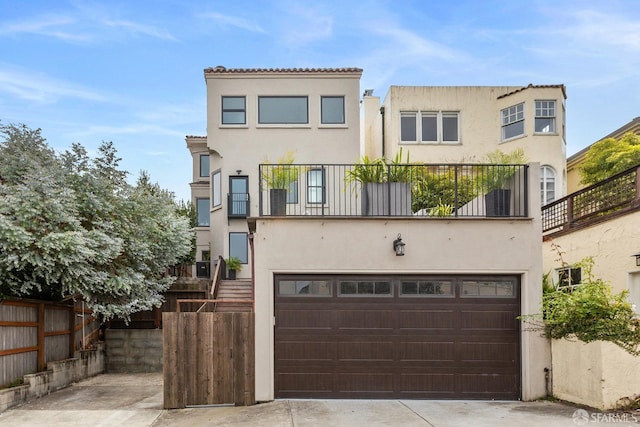 mediterranean / spanish-style house featuring a balcony and a garage