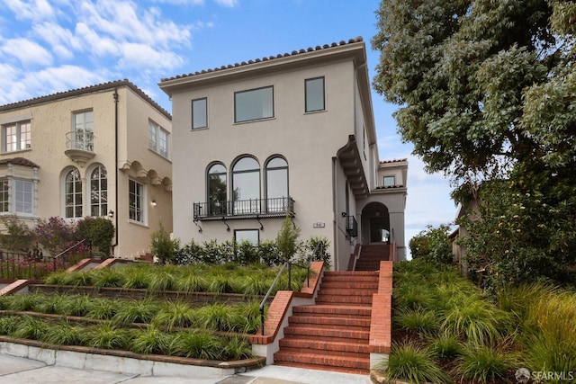 mediterranean / spanish-style house with a balcony