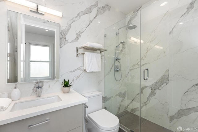 bathroom featuring walk in shower, vanity, and toilet