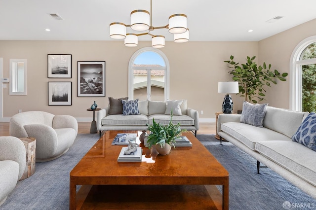 living room with an inviting chandelier and hardwood / wood-style floors