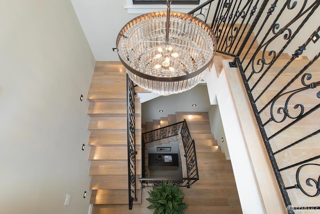 room details with wood-type flooring and an inviting chandelier