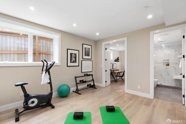 exercise area with light wood-type flooring