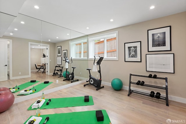 exercise room featuring light wood-type flooring