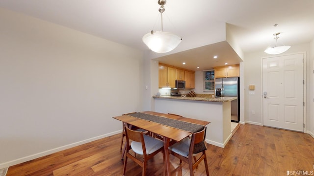 dining space with light wood-type flooring